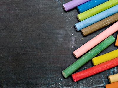 An image of chalk on a blackboard, the name of our e-learning platform