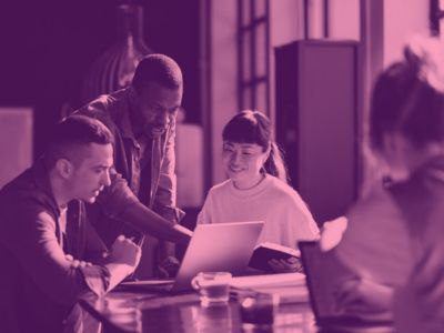 Photograph of students looking at a computer